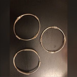 Three silver bangle bracelets